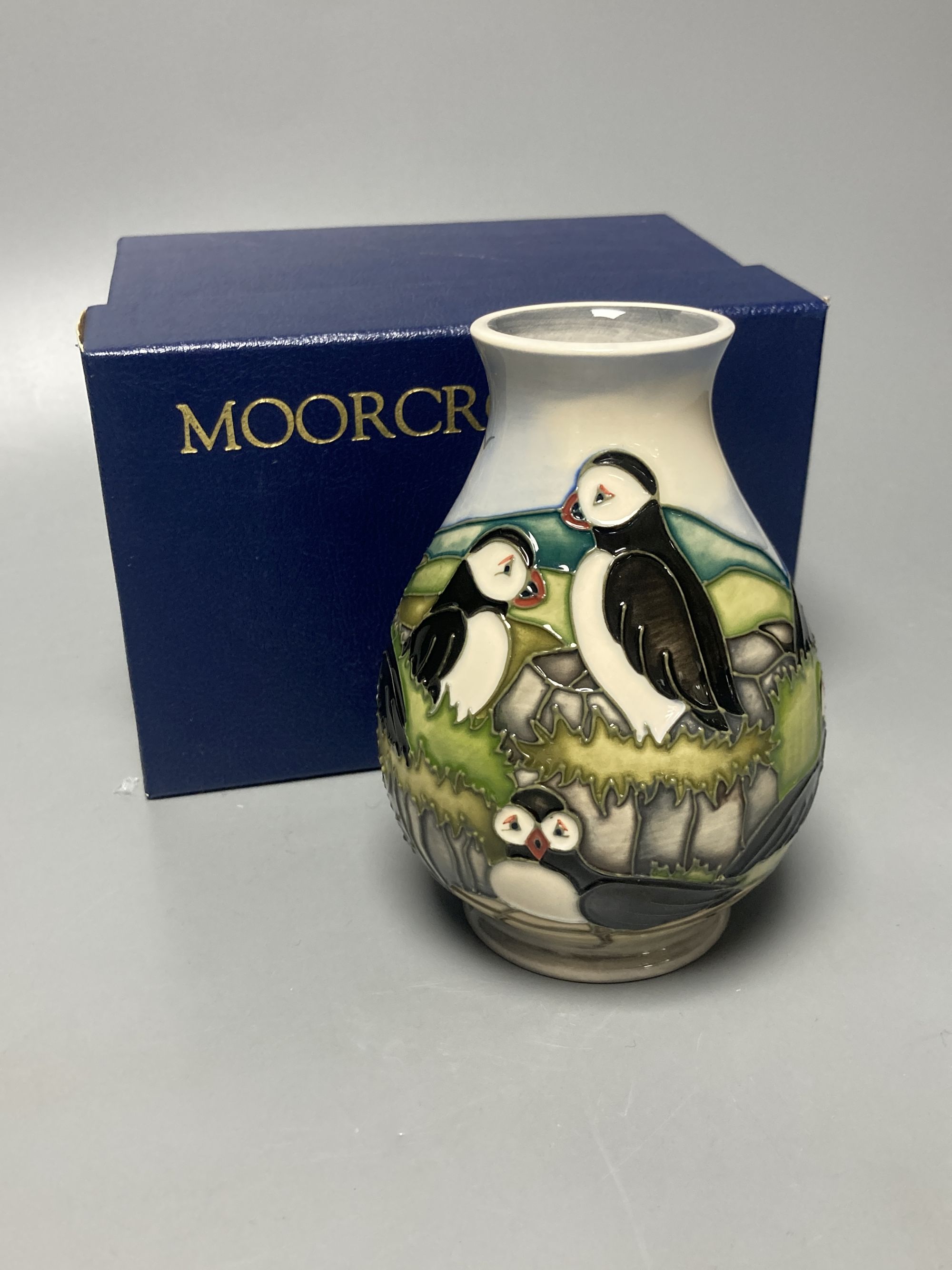 A Moorcroft puffin pattern vase, decorated by Kerri, height 14cm, boxed